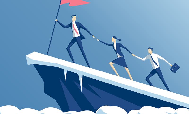 Businesspeople climbing mountain holding red flag.