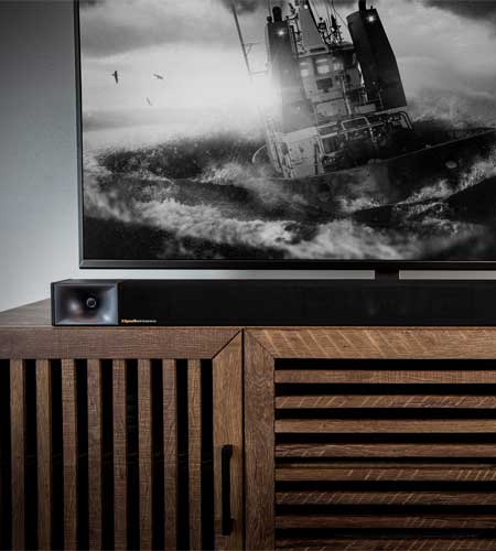 TV with ship image on wooden cabinet.
