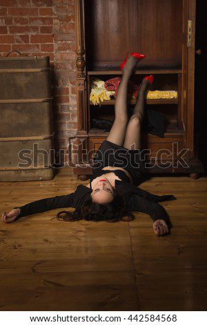 Person lying on floor with legs raised.