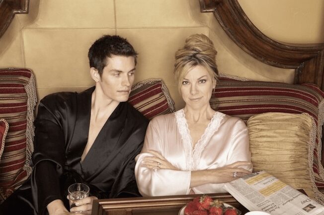 Couple in robes with breakfast in bed.